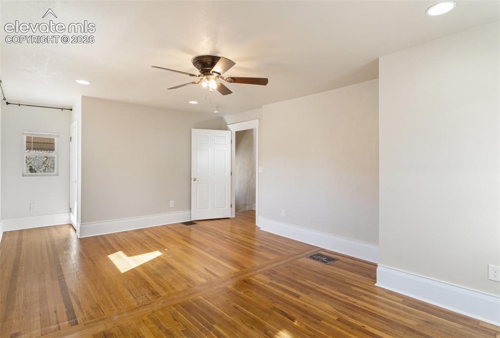 Image 33 of 42: Hardwood flooring with inlaid details, recessed lighting, ceiling fan, whit