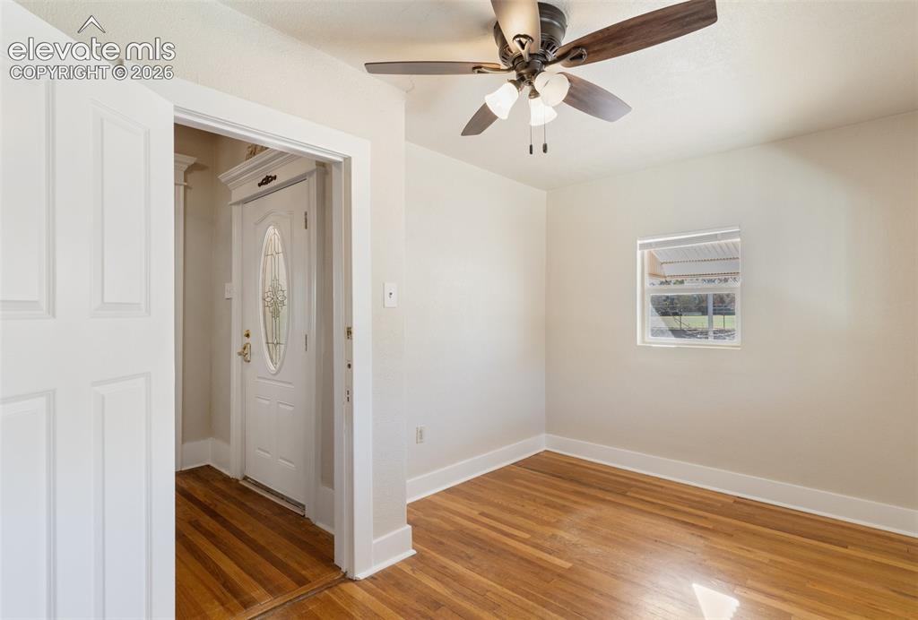 Image 40 of 42: Hardwood flooring, white interior door, front entry door with oval glass in