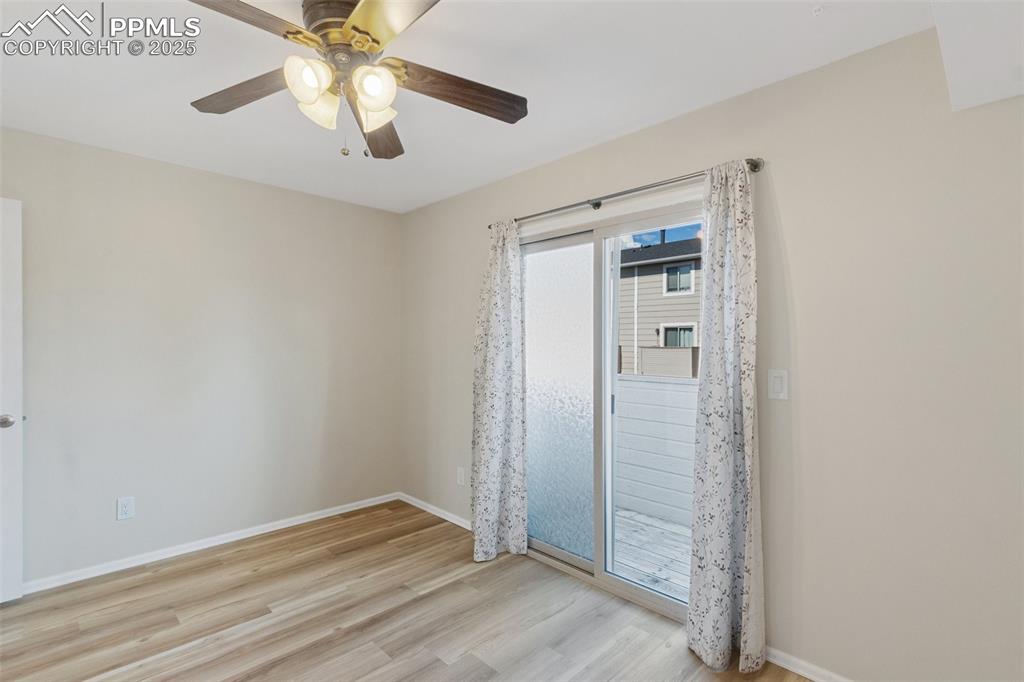 Image 10 of 26: Spare room with wood finished floors and ceiling fan