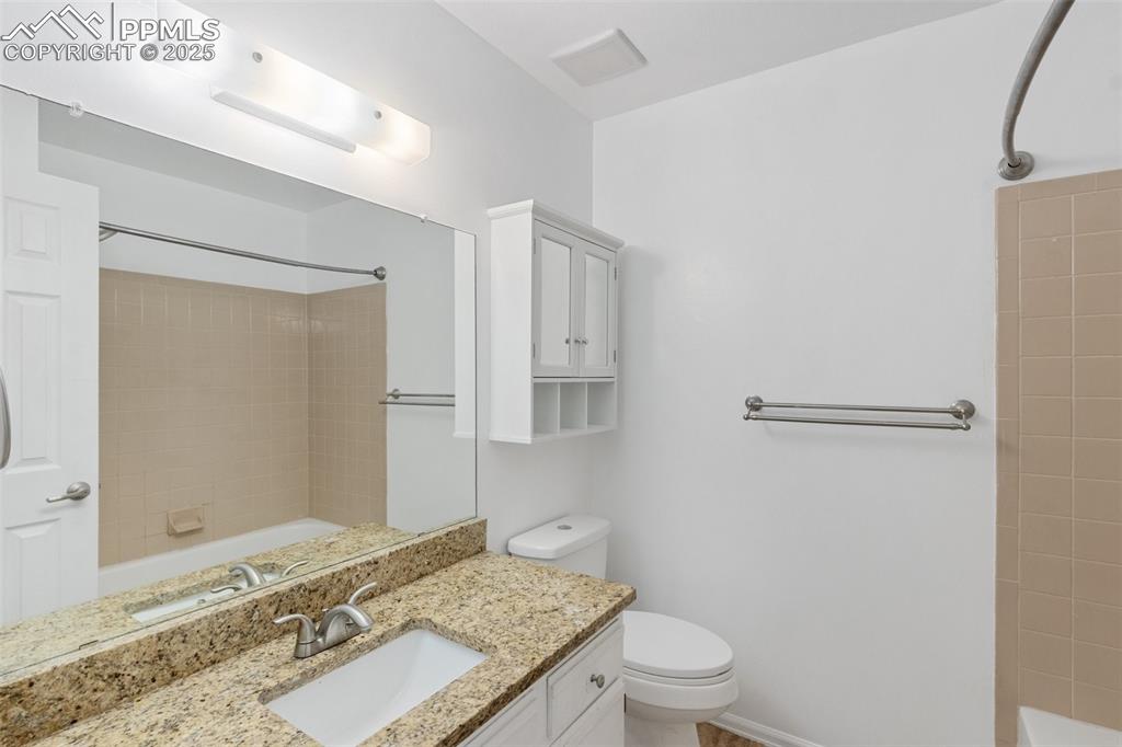 Image 13 of 26: Full bath with vanity and washtub / shower combination