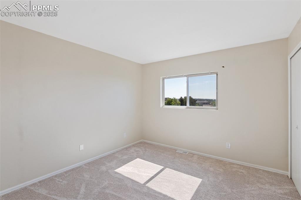 Image 17 of 26: Unfurnished room with light carpet and baseboards