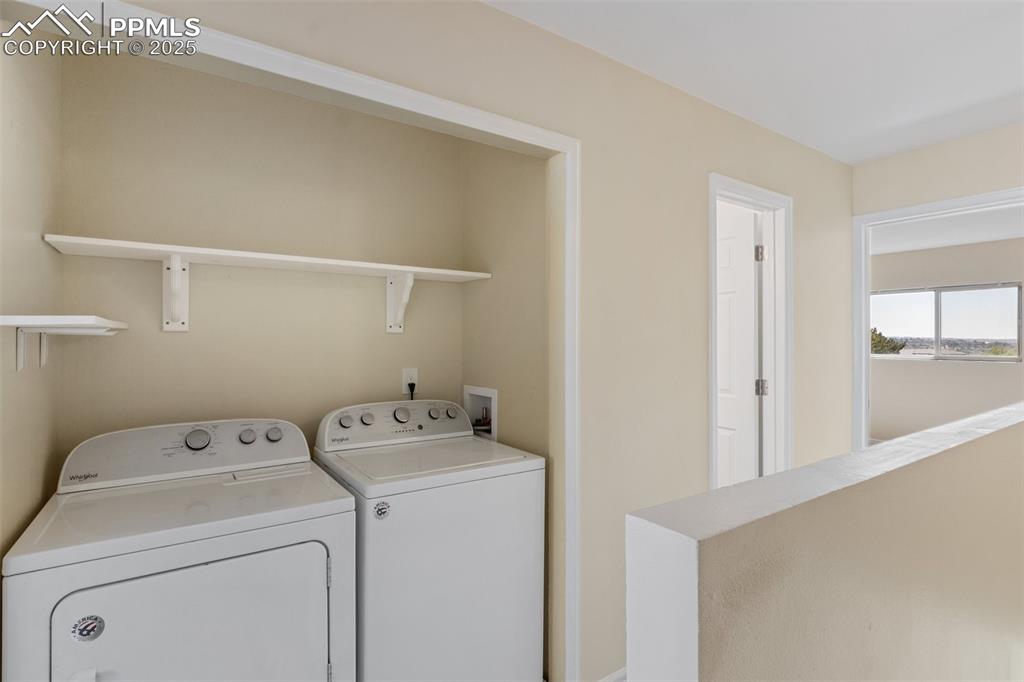 Image 18 of 26: Laundry room featuring independent washer and dryer