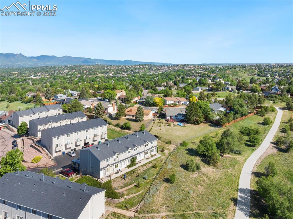 Image 24 of 26: Aerial perspective of suburban area with a mountain backdrop