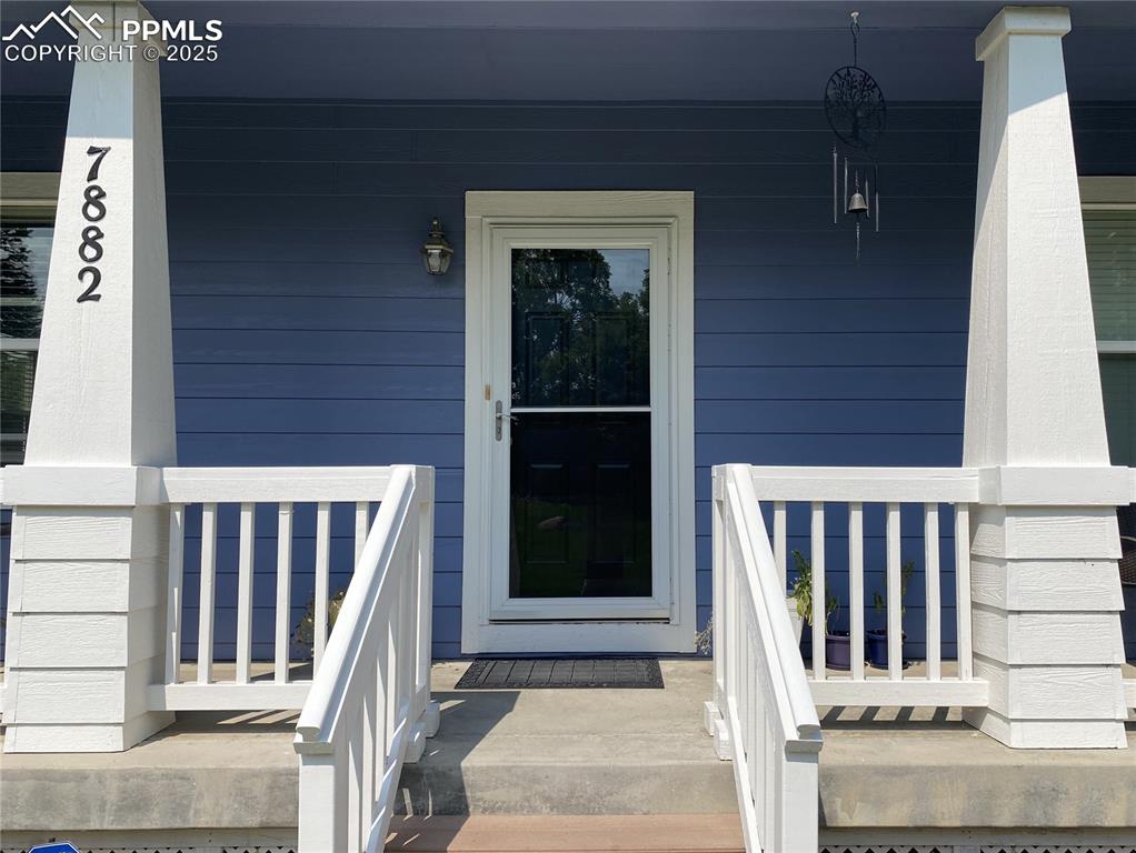 Image 11 of 41: With newly painted porch railings, the home offers a welcoming entry, enhan
