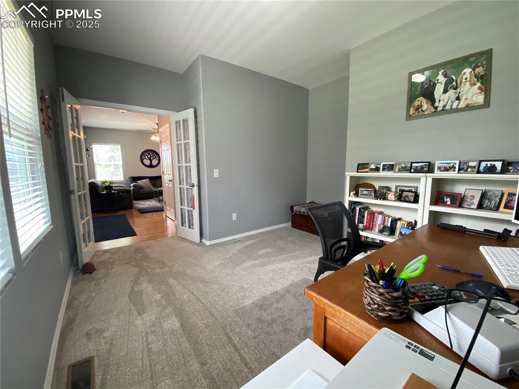 Image 14 of 41: This versatile front room can function as a bedroom or home office, perfect