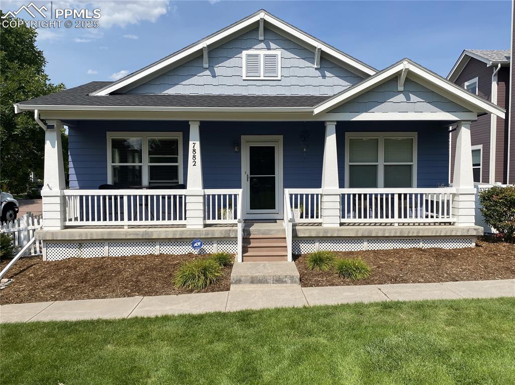 Image 2 of 41: Relax and unwind on the friendly front porch, perfect for evening outdoor l