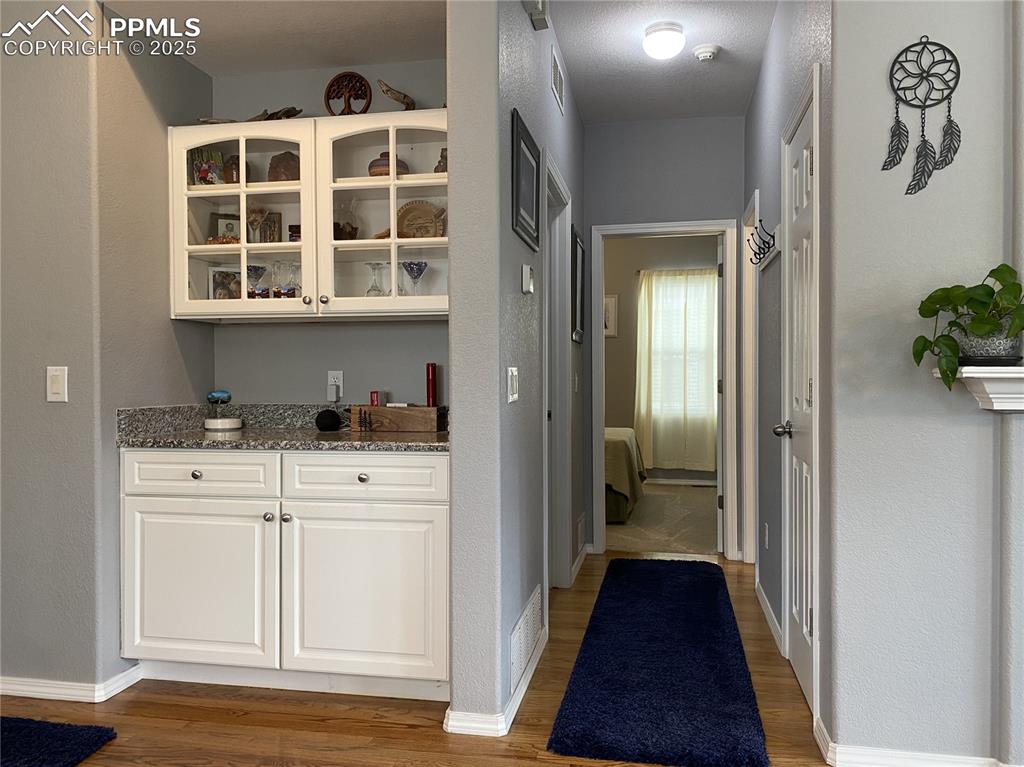 Image 21 of 41: The convenient dry bar adds extra storage and workspace for gadgets, kitche