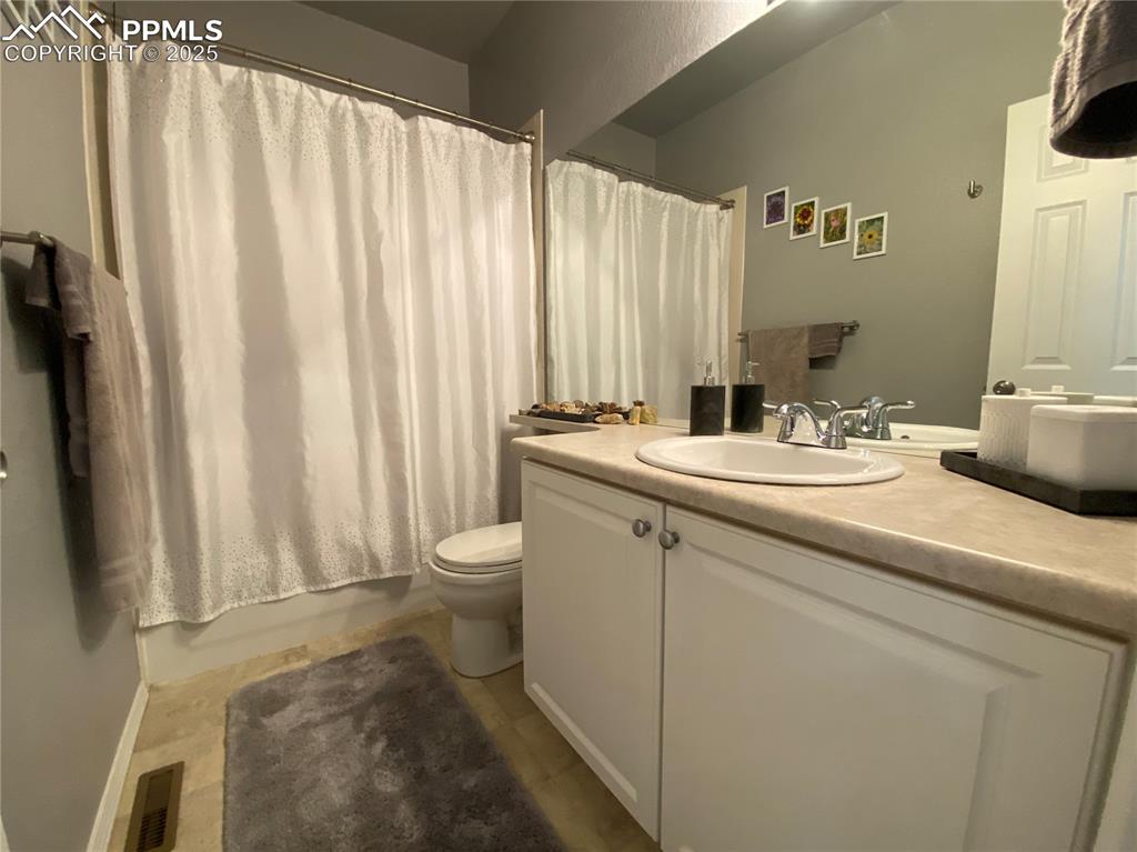 Image 22 of 41: Enjoy a bright and refreshed full guest bathroom with a new sink, contempor