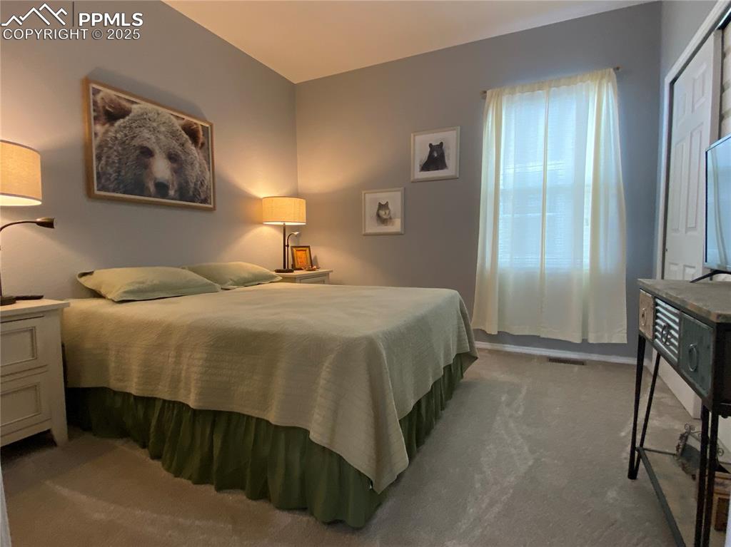 Image 23 of 41: This guest-ready second bedroom provides versatile space for family or frie