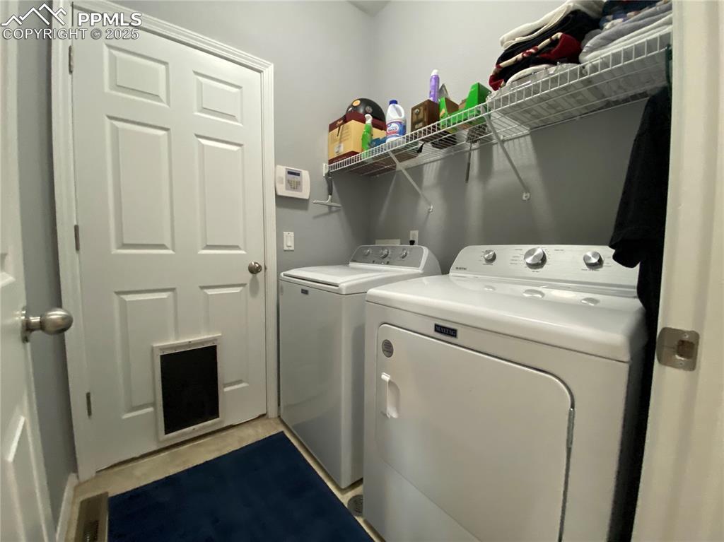 Image 27 of 41: Enjoy the functional layout of a laundry area that connects to the garage,