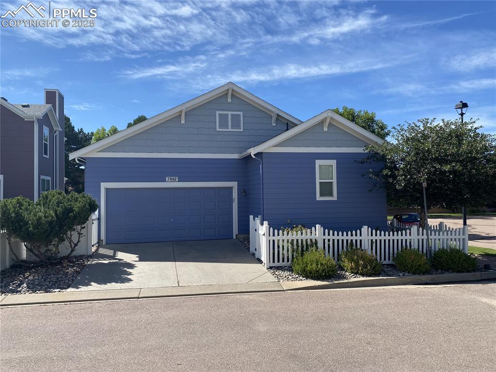 Image 30 of 41: The back view of the home showcases charming curb appeal, landscaped outdoo