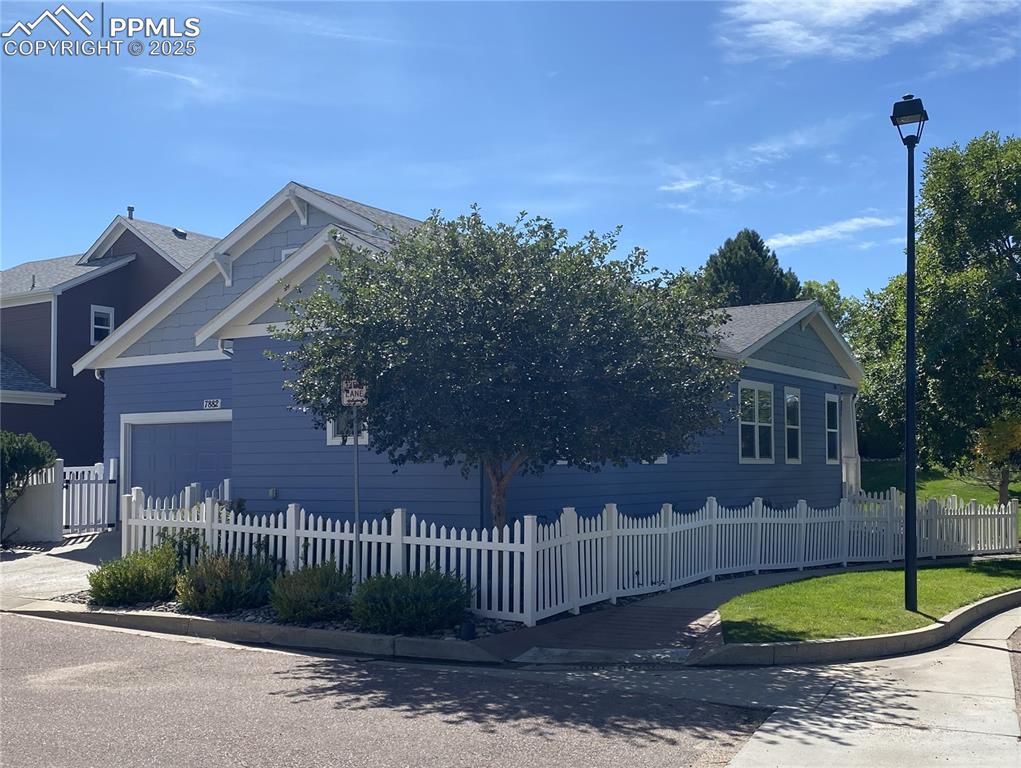 Image 7 of 41: The updated landscaping beautifully complements the classic white picket fe