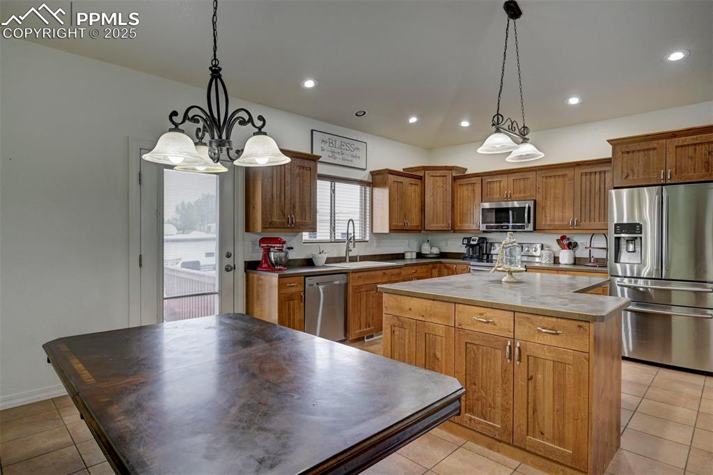 Image 18 of 47: Kitchen featuring appliances with stainless steel finishes, light tile patt