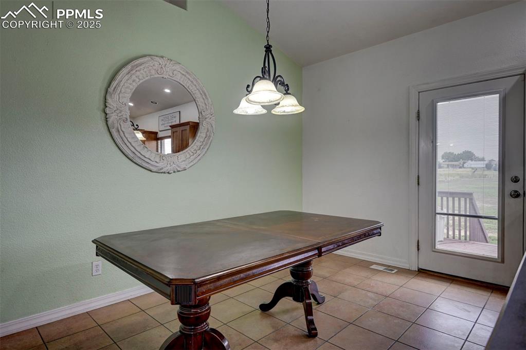 Image 20 of 47: Dining area featuring tile patterned floors and lofted ceiling