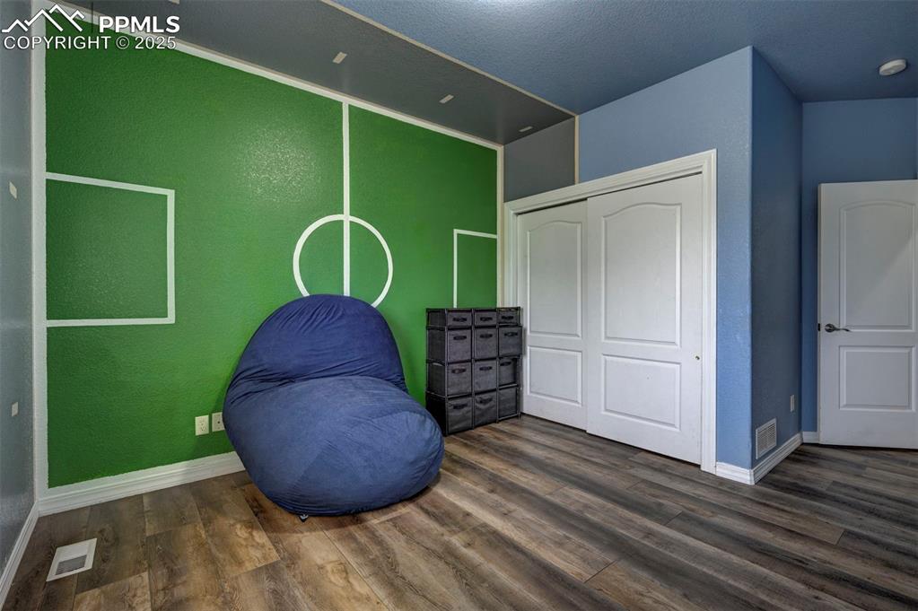 Image 34 of 47: Unfurnished room with dark wood-type flooring and baseboards