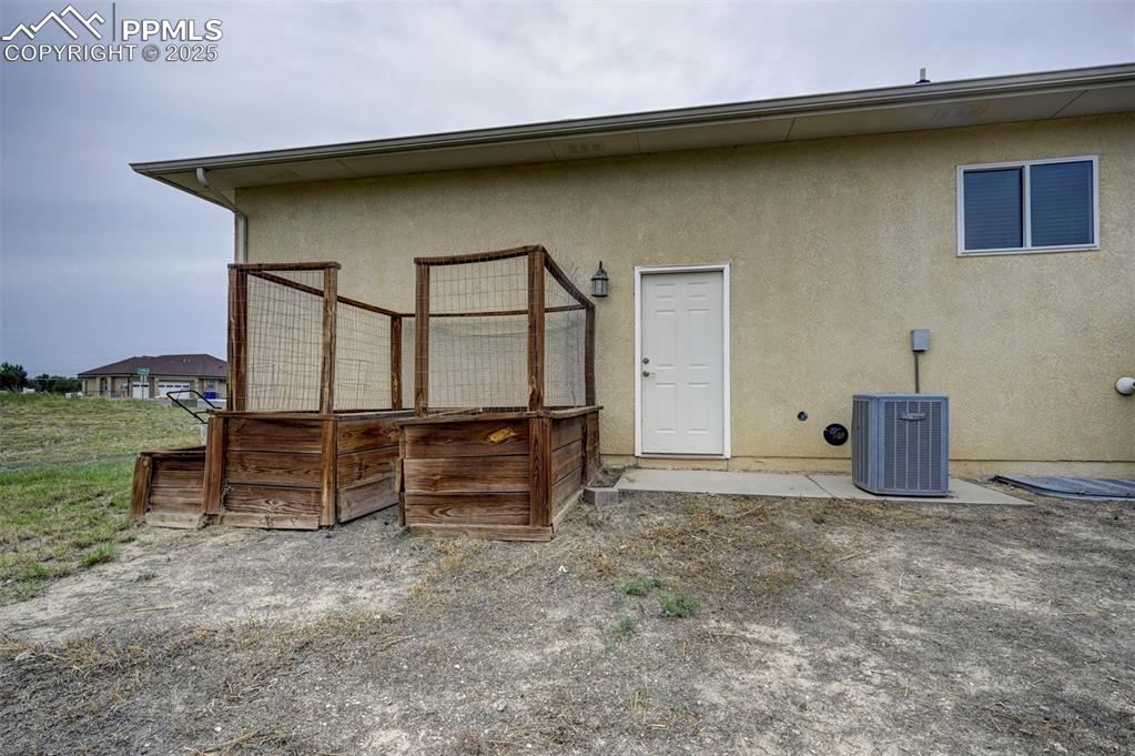 Image 40 of 47: Back of property featuring stucco siding