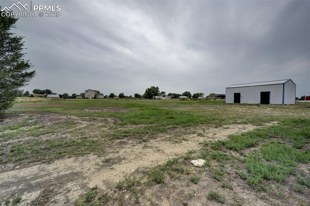 Image 46 of 47: View of yard featuring an outbuilding