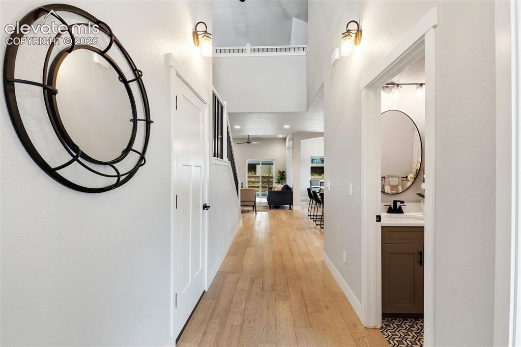 Image 12 of 43: Hallway featuring wood-finish flooring, recessed lighting, and wall-mounted