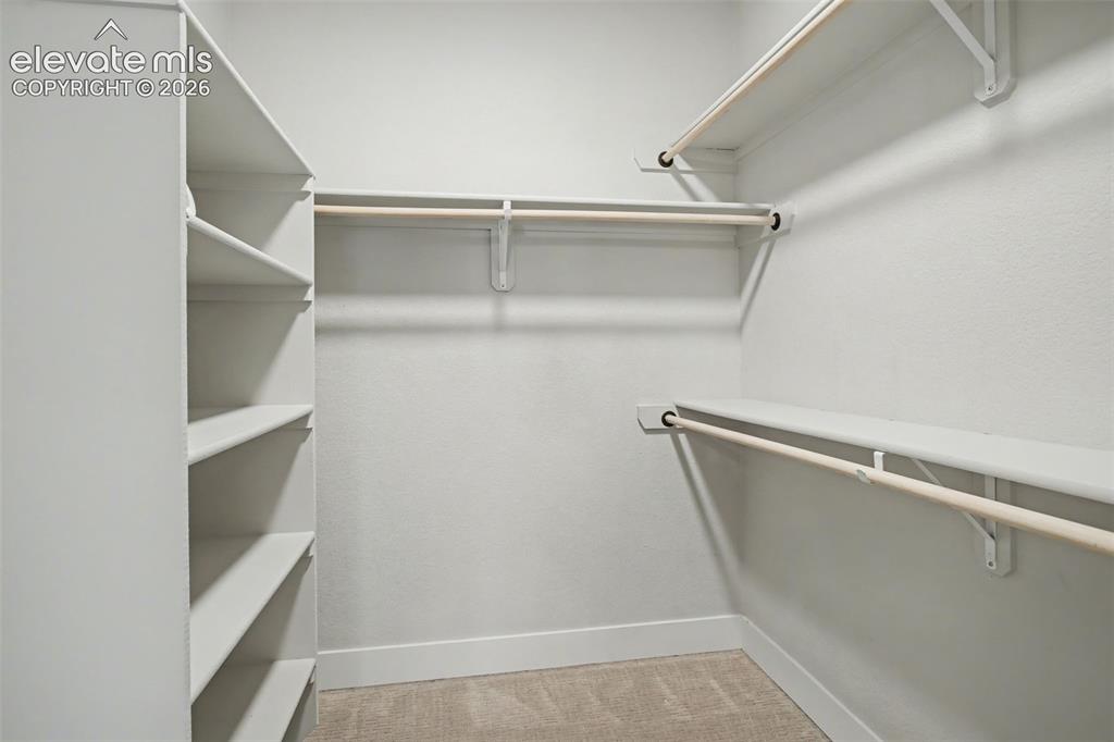 Image 24 of 33: primary closet attached to laundry room