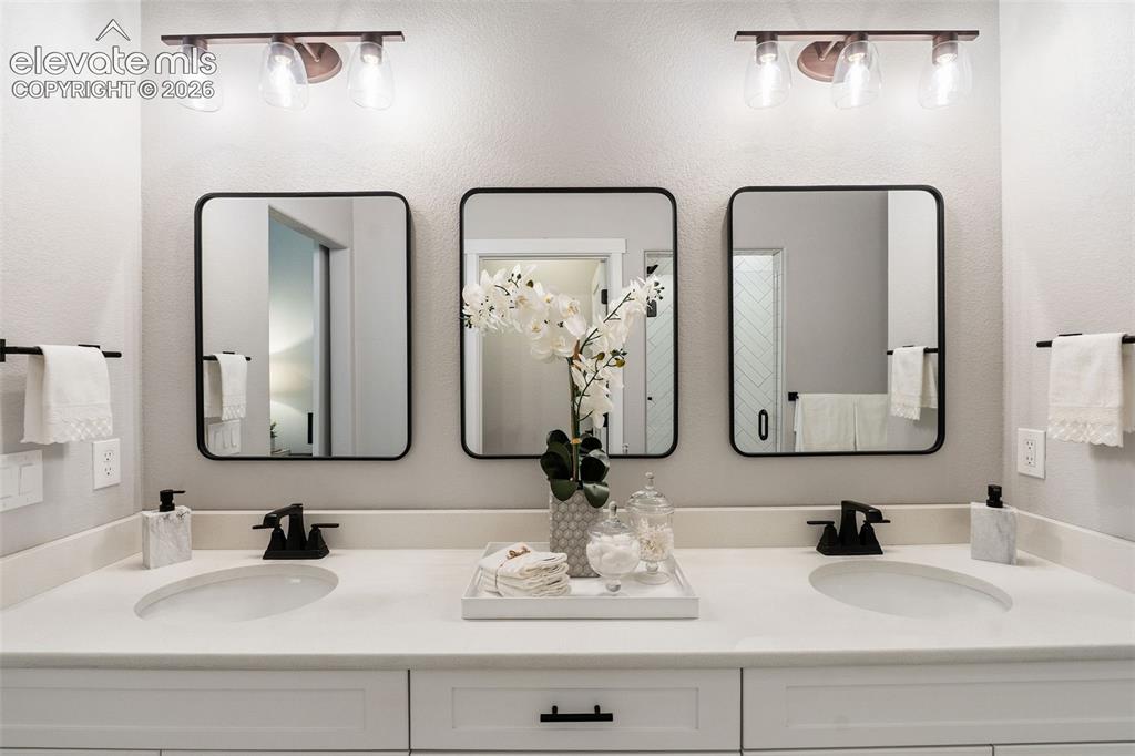 Image 28 of 43: Dual vanity with integrated sinks and white countertops
