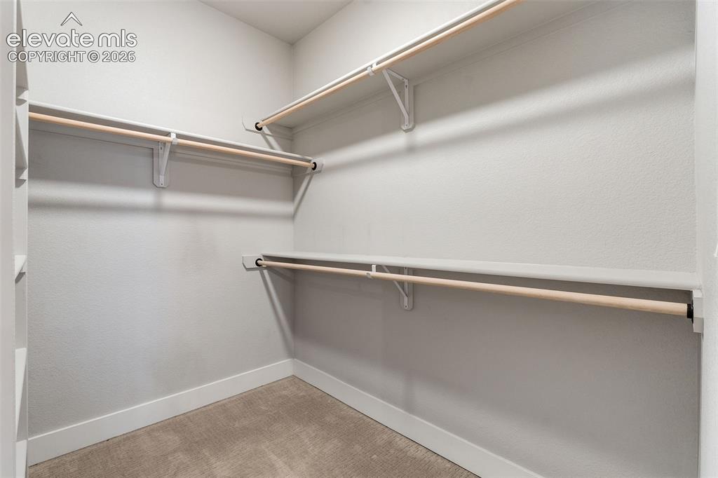 Image 31 of 43: Built-in shelving and hanging rods