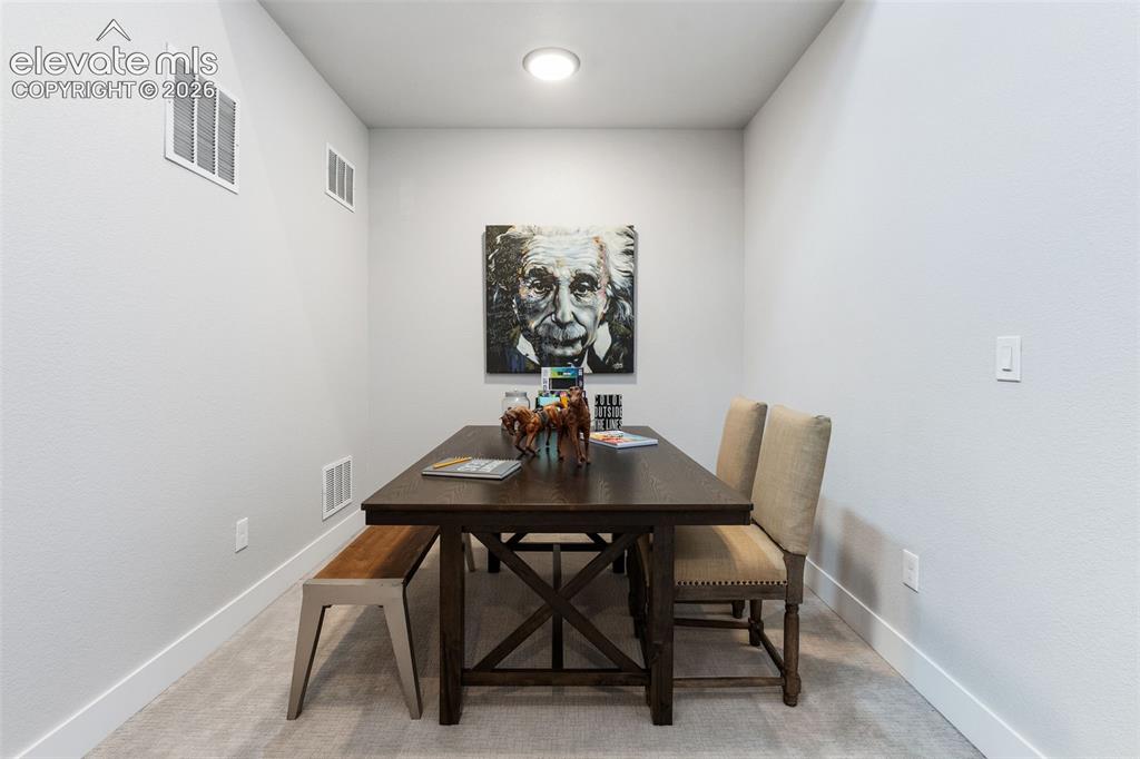 Image 34 of 43: Recessed ceiling lighting, light gray wall paint, and light gray carpeting