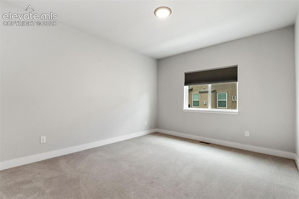 Image 39 of 43: Bright secondary bedroom featuring neutral wall finishes, recessed ceiling 