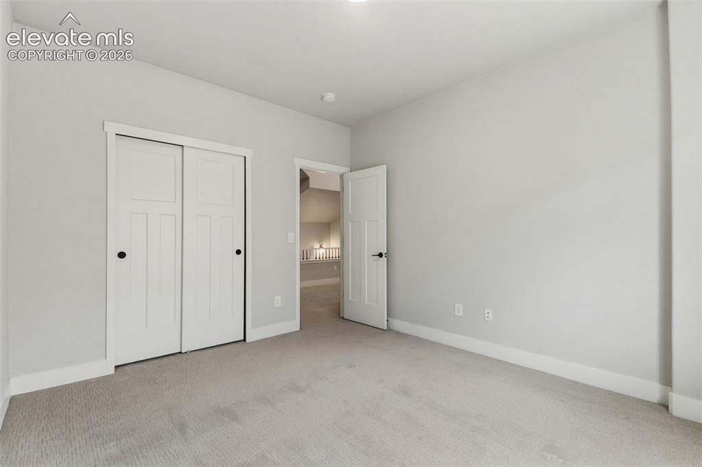 Image 42 of 43: Neutral wall finishes, recessed lighting, and carpeted flooring