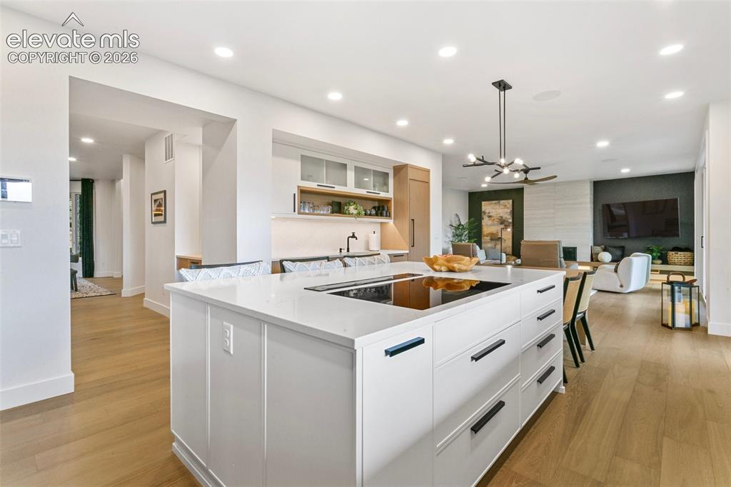 Image 10 of 49: Large kithcen island with induction cooktop is also plumbed for gas