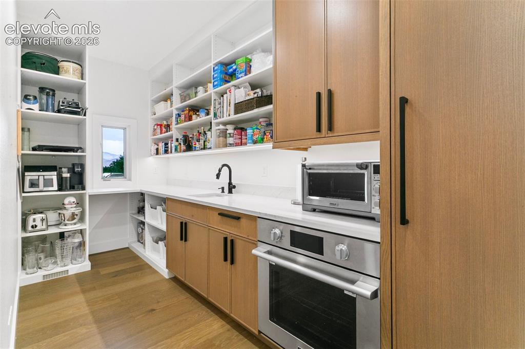 Image 14 of 49: Walk behind Pantry/Prep Kitchen with full size oven