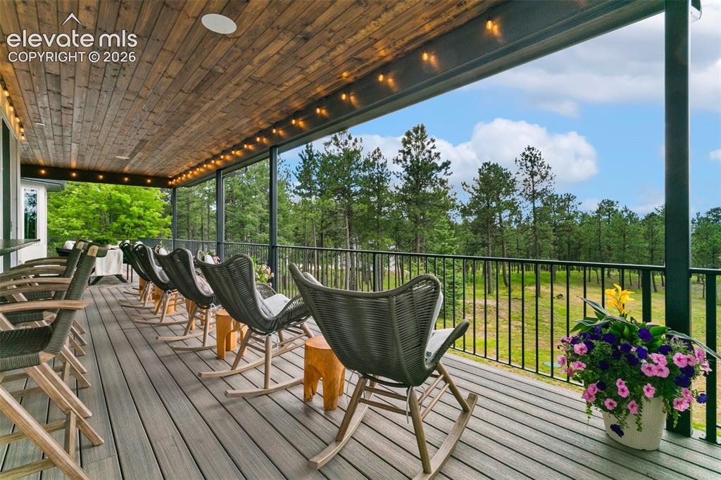 Image 16 of 49: Sit back relax and enjoy the unobstructed views from the covered deck, comp