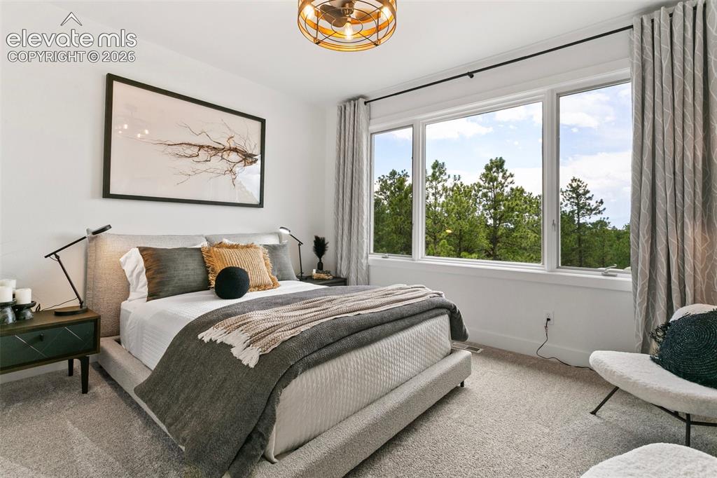 Image 27 of 49: Gorgeous Pikes Peak Views from this upper
Bedroom shown with a Queen Size