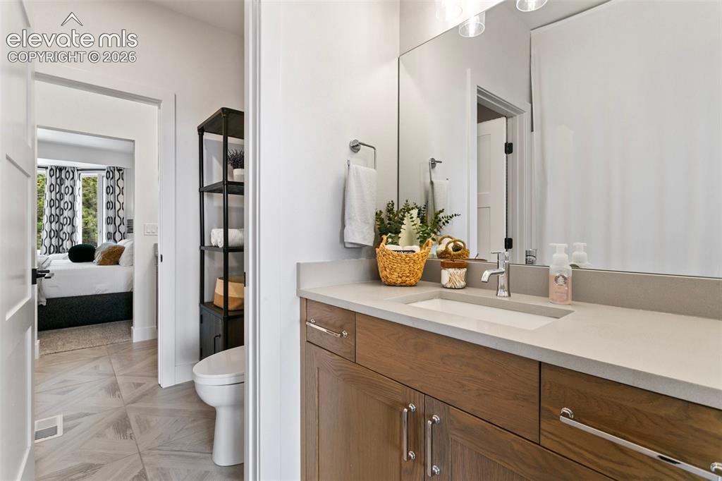 Image 28 of 49: Private vanity and walk-in-closet adorns both of the Jack & Jill Upper Bedr