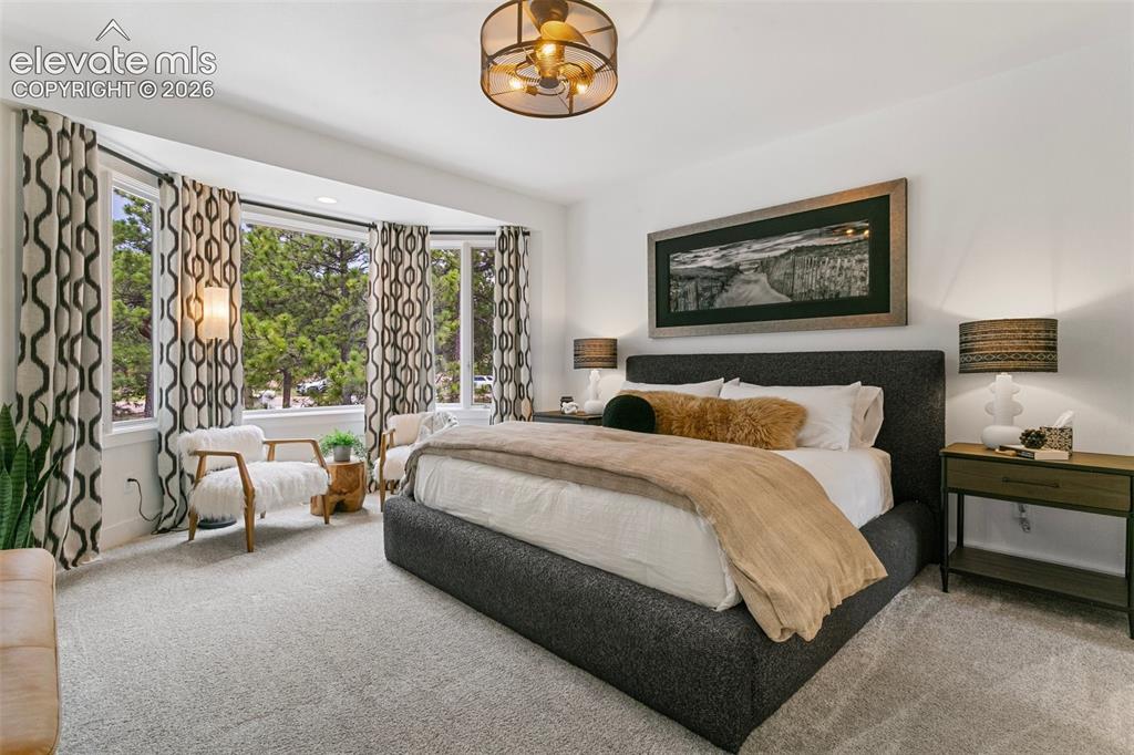 Image 29 of 49: Oversized bedroom with bay window sitting area