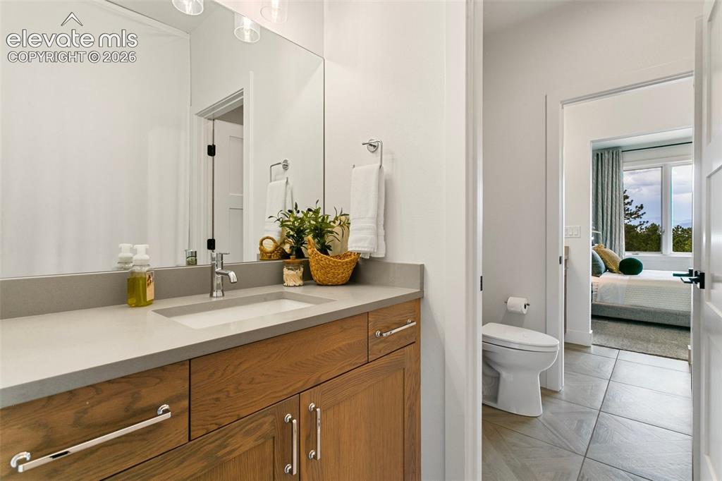 Image 30 of 49: Private vanity and walk-in-closet adorns both of the Jack & Jill Upper Bedr