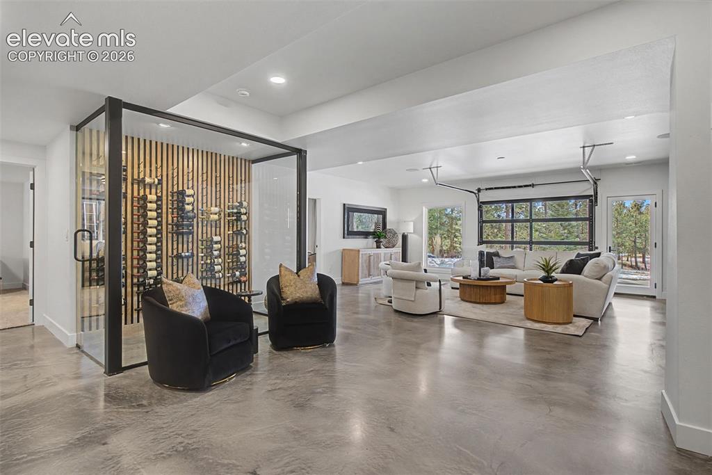 Image 33 of 49: More space for games, pool table or? Note the glass garage door tha opens o