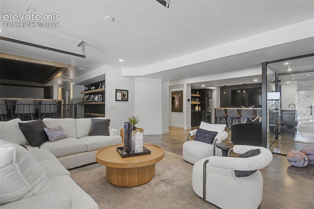 Image 34 of 49: Flexible rec room space adjoins the theatre to the walk behind bar/wine cel