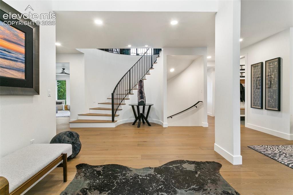 Image 4 of 49: Entry offers a grand  curved staircase and a 2 Story welcome you need to ap