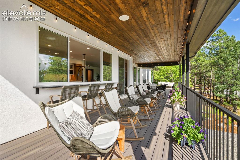 Image 41 of 49: Pass through window and from the kitchen offers a countertop to blend the o