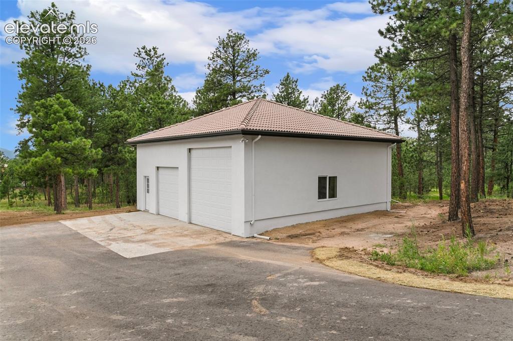 Image 43 of 49: Detached RV garage/Shop 35X35 wit one 12x12 door and one 9x9 door.