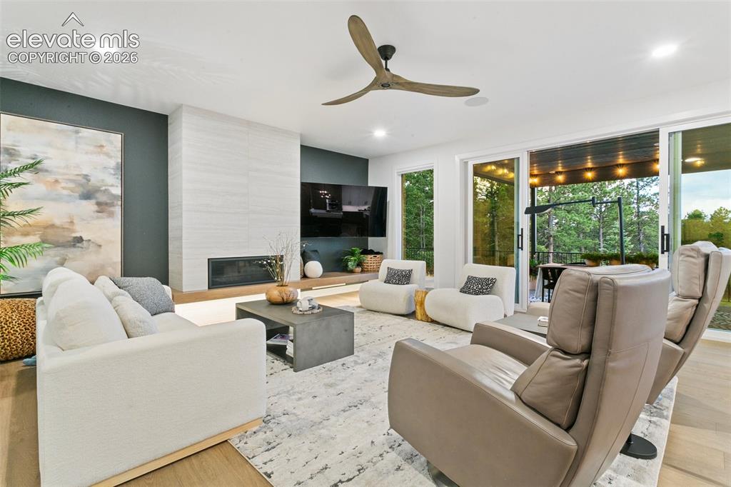 Image 6 of 49: Walk out to the covered deck or enjoy the views from the expansive window/s