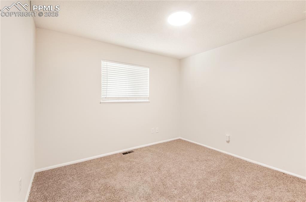 Image 12 of 25: Main level bedroom room 2 with baseboards