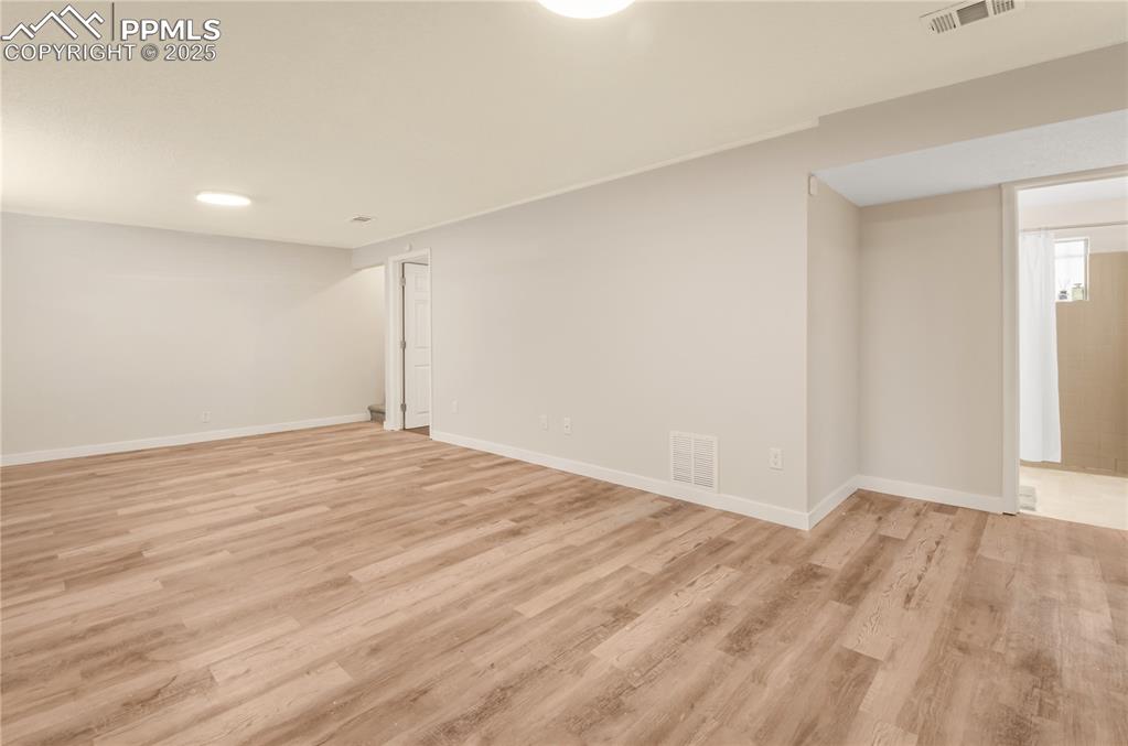Image 15 of 25: Family room featuring light wood-style flooring