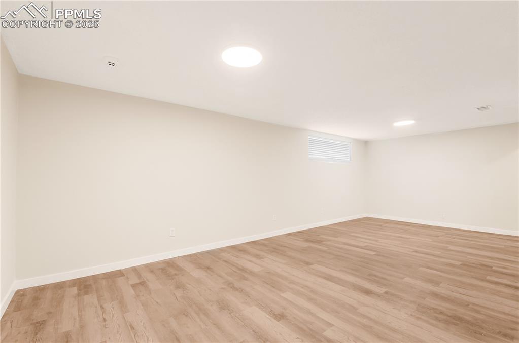 Image 16 of 25: cwith light wood finished floors and baseboards