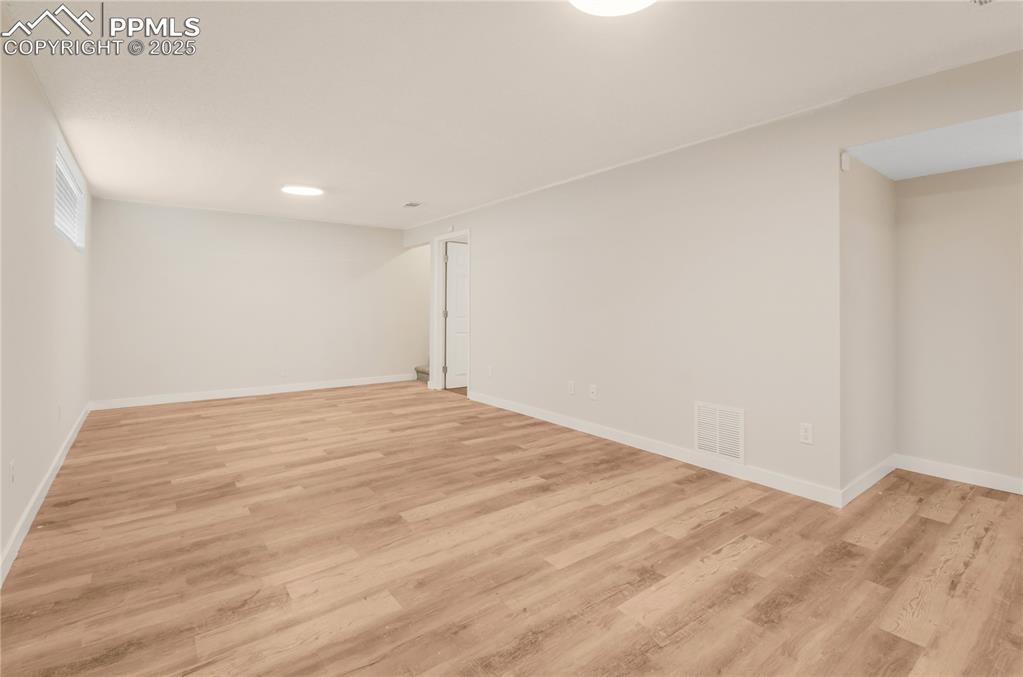 Image 17 of 25: Family room featuring light wood-type flooring and baseboards