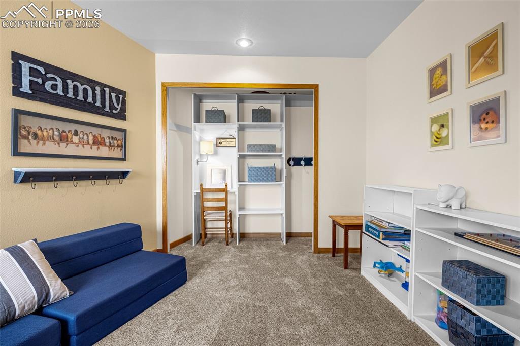 Image 20 of 42: Sitting room with carpet and baseboards