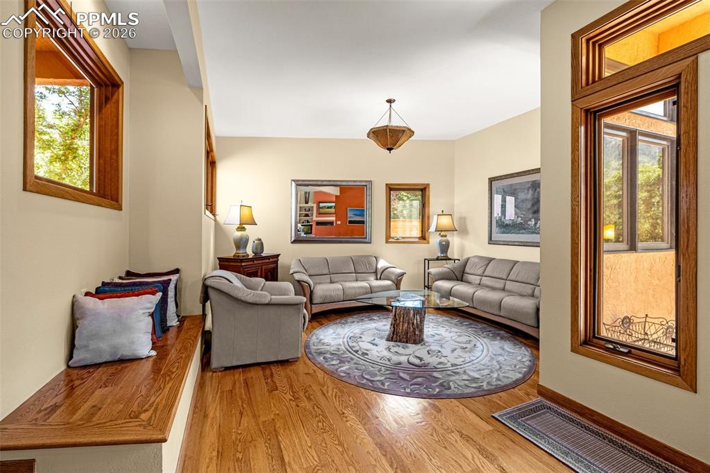Image 31 of 42: Living room with wood finished floors