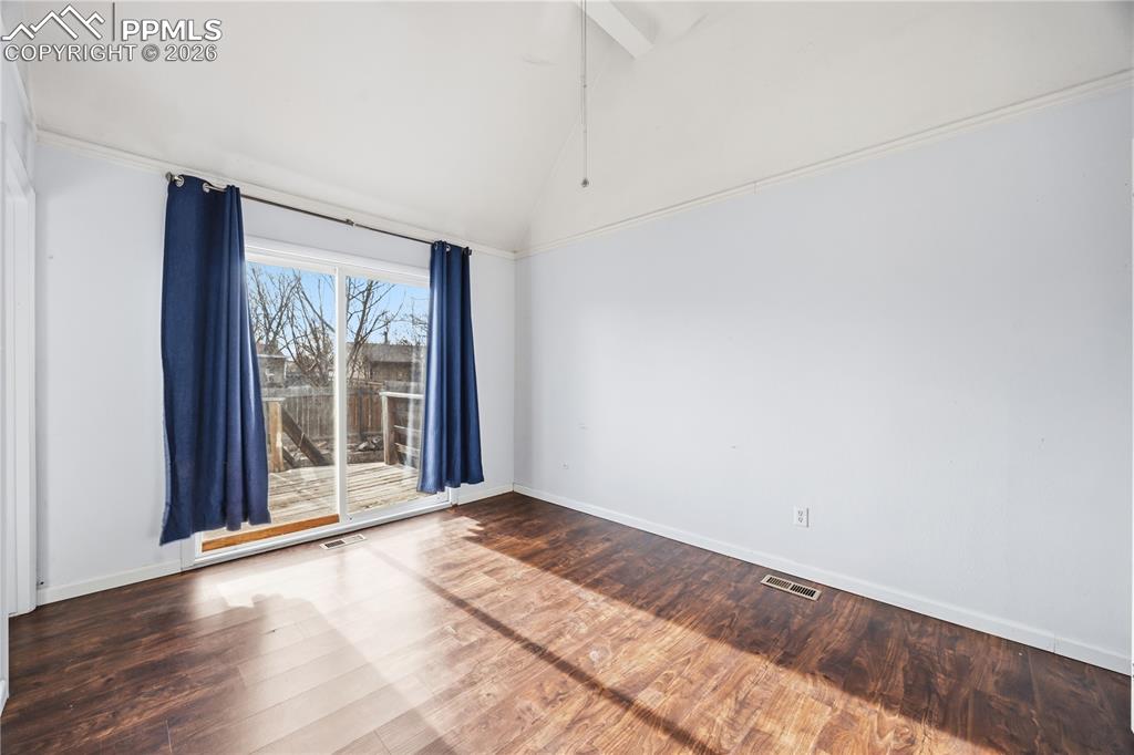 Image 12 of 27: The upper level Primary Bedroom is a private retreat with a slider to a bac