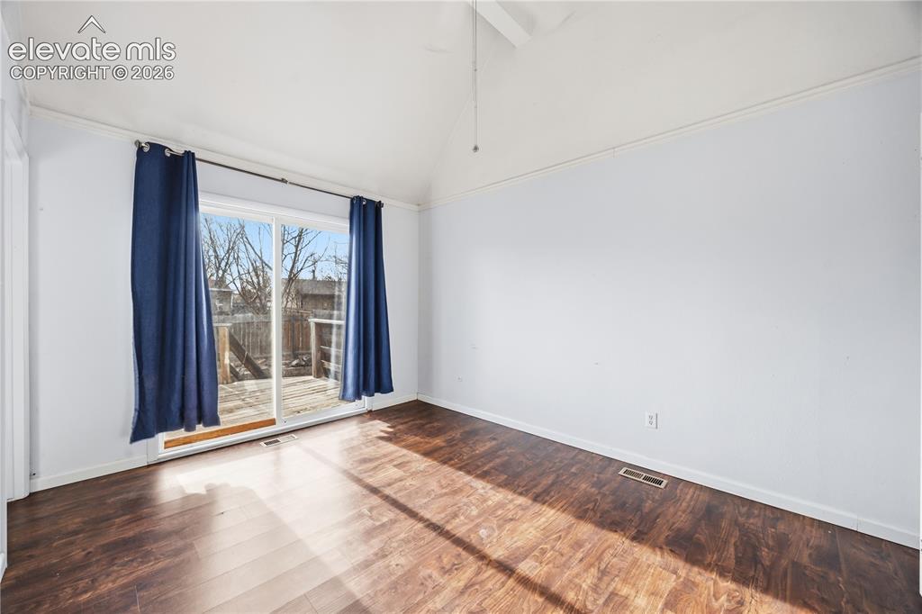 Image 12 of 27: The upper level Primary Bedroom is a private retreat with a slider to a bac