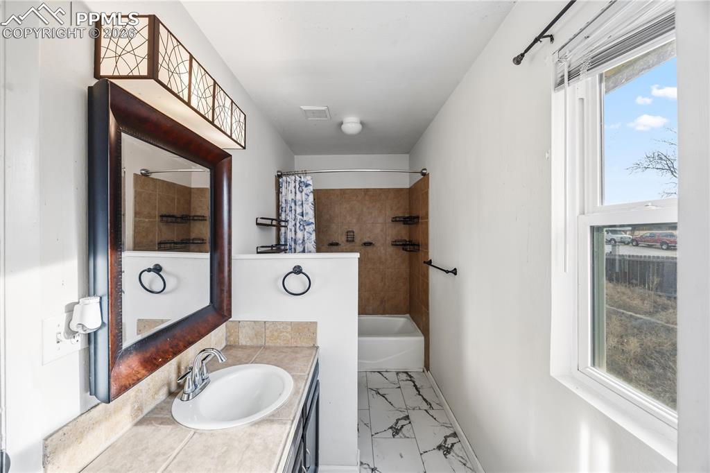 Image 17 of 27: Primary full bathroom.